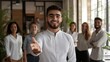 © bismillah_bd - Smiling professional offering handshake in modern office