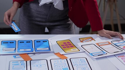 Wall Mural - ux designer arranging paper prototypes for a mobile application, focusing on user interface and user