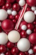 © Albert - A tight shot of a candy cane against a backdrop of various candies on a white and red background