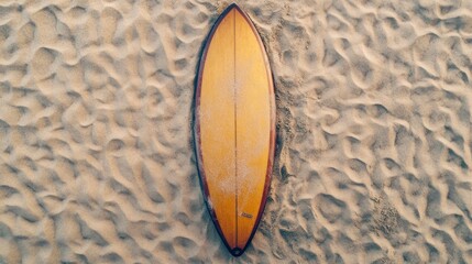 Wall Mural - A vintage yellow surfboard resting on sandy beach textures.