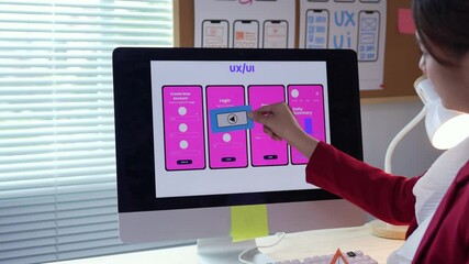 Wall Mural - woman working as a ux designer, creating a mobile application through paper prototyping techniques a
