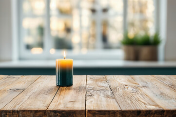 Burning candle standing on a wooden table in a cozy room