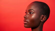 © Alexander - African model, short hair, side view, close-up isolated on red background