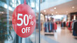 © Ruslan - 50% discount banner on the glass of a store in a shopping center