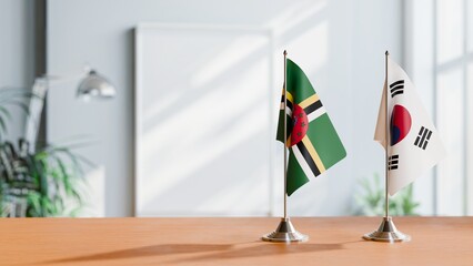 FLAGS OF DOMINICA AND KOREA SOUTH ON TABLE