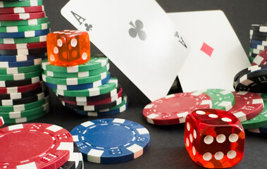 Poker cards and gambling chips on dark background