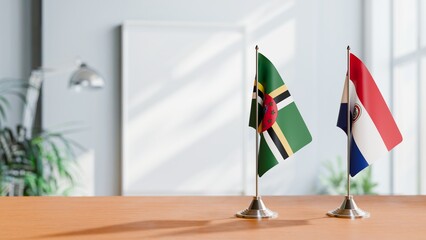 FLAGS OF DOMINICA AND PARAGUAY ON TABLE