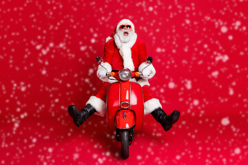 Poster - Full length photo of retired grandfather white beard mad ride retro moped open mouth spread legs fast ride down hill wear x-mas costume coat sunglass cap isolated red color background