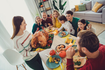 Poster - Photo of happy nice people celebrating thanksgiving day together serving main dish stuffed turkey indoors