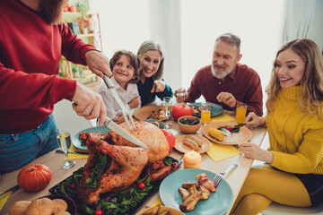 Poster - Photo of big family celebrating thanksgiving day man cutting traditional dish baked turkey indoors