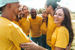 © Davide Angelini - Multiracial group of people hugging outdoors - Happy friends having fun hanging outside - Youth community concept with guys and girls supporting each other