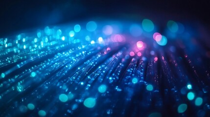 Abstract glowing fiber optic cables in blue and pink colors.