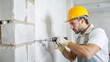© Alexandr Peers - Construction worker with precision tools repairing building foundation