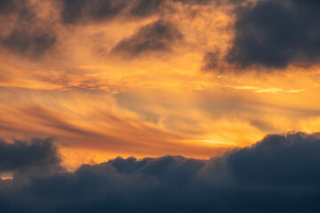 Wall Mural - orange sky horizon with dramatic cloudscape, sunset shot .