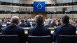 © Maksym - A powerful back view of politicians listening intently during a session, with the EU flag prominently featured, highlighting the importance of dialogue in EU decision-making.