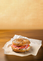 Canvas Print - Close-up of Lox Bagel with onions on paper sheet.