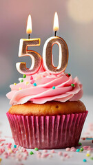 Birthday cupcake with burning lit candle with number 50. Number fifty for fifty years or fiftieth anniversary.