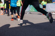 © tsuguliev - Marathon runners crowd, sportsmen participants start running the half-marathon in the city streets, crowd of sportswomen joggers in motion, group athletes outdoor training competition in a summer day