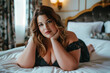 © staras - Sexy plus size curvy model with big breasts lies on bed, fat chubby woman in luxury hotel room