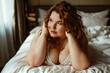 © staras - Sexy plus size curvy model with big breasts lies on bed, fat chubby woman in luxury hotel room