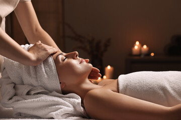 Canvas Print - Attractive woman enjoying face massage in spa salon, closeup