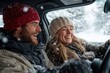 © Milos - A couple enjoys a winter drive, laughing together in a snow-covered car, capturing the playful spirit and joy of shared moments during their snowy road trip adventure.