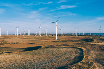 Aerial view of turbines propellers rotating from wind power producing clean eco energy and saving natural resources from climate change. Alternative electricity generation with friendly technology