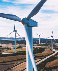 Birds eye view of turbines propellers rotating from wind power producing clean eco energy and saving natural resources from climate change. Alternative electricity generation with friendly technology