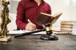 © NanSan - A male lawyer is working at his desk on an online judicial review, focusing on justice, fairness, and legal compliance.He reviews cases, contracts, and legal matters based on general law principles
