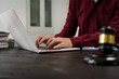 © NanSan - A male lawyer is working at his desk on an online judicial review, focusing on justice, fairness, and legal compliance.He reviews cases, contracts, and legal matters based on general law principles