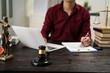 © NanSan - A male lawyer is working at his desk on an online judicial review, focusing on justice, fairness, and legal compliance.He reviews cases, contracts, and legal matters based on general law principles
