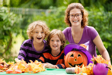 Family decorating home. Halloween arts and crafts.