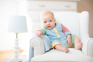 Wall Mural - little baby on white chair