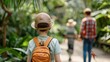 © GreenMOM - A child walks through a lush garden, leading the way for a family adventure surrounded by greenery and nature's beauty.