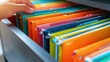 © GreenMOM - A close-up of colorful file folders in a drawer, showcasing organization and productivity in an office environment.