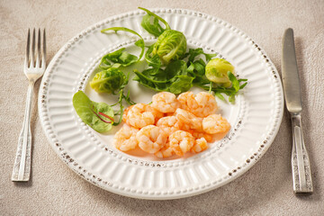 Wall Mural - Shrimp poached in coconut oil, served with greens and Brussels sprouts