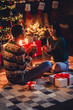 © deagreez - Vertical full length photo of happy young couple drink tea cacao dressed christmas garment tradition atmosphere decor house indoors room