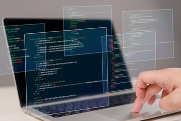 Wall Mural - hands typing on laptop with programming code on screen, representing software development. perfect f