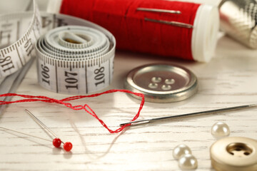 Poster - Different sewing tools on white wooden table, closeup