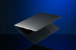 © Connect Images - Floating silver laptop with a sleek design against a blue gradient background.