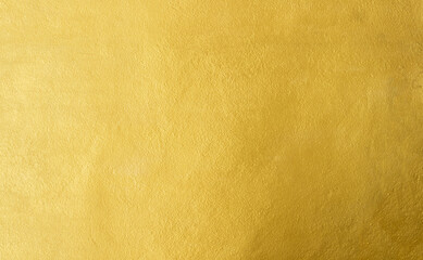 gold wall texture background. yellow shiny gold foil paper sheet surface, vibrant golden luxury wall