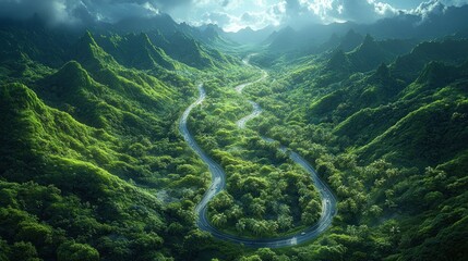 Wall Mural - Lush green landscape with a winding road through mountainous terrain.