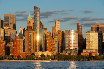 Sunset light on Battery Park and Lower Manhattan skyscrapers in New York City. Cityscape from the Hudson River