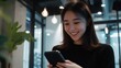 © WS Studio 1985 - Happy Woman Using Smartphone in Modern Workspace