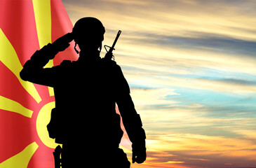 Canvas Print - Flag of North Macedonia with soldier silhouette against the sunset. National Holidays concept