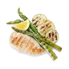 Delicious grilled vegetables, chicken breast and lemon slice isolated on white, top view