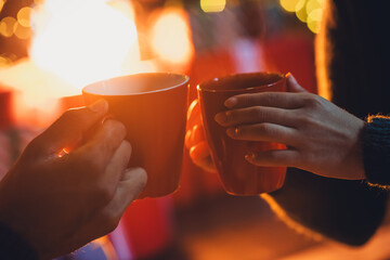 Poster - Photo of winter season romantic relationships yellow lights new year holiday near illumination garlands cheers drinking mulled wine