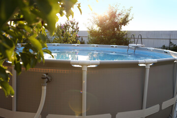 Canvas Print - Above ground swimming pool in garden on sunny day