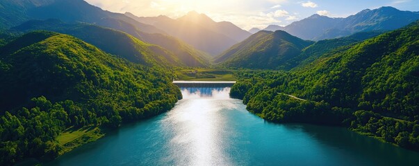 Breathtaking view of lush green mountains reflecting in a serene river under a bright sunny sky.