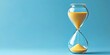 © Monirknn - an hourglass filled with sand flowing steadily. isolated on blue background with copy space. tracking time concept, generative ai